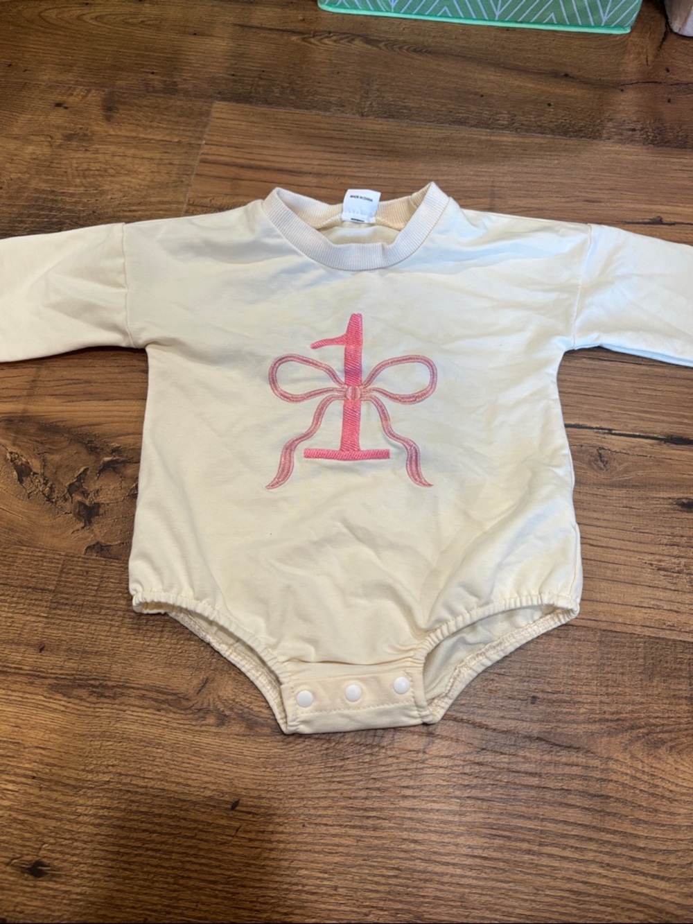 Cream Long-Sleeve Baby One-Piece with Pink Bow